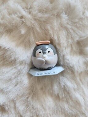 Cute baby penguin figure holding a small bird